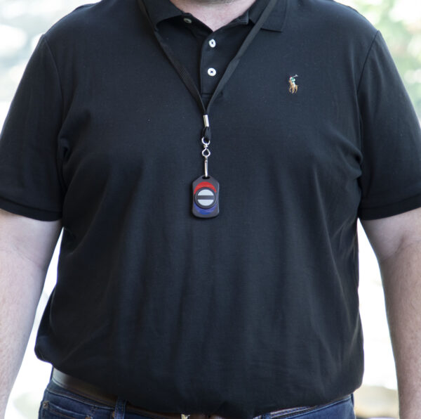 Image of a man wearing the wireless panic button on a lanyard around their neck